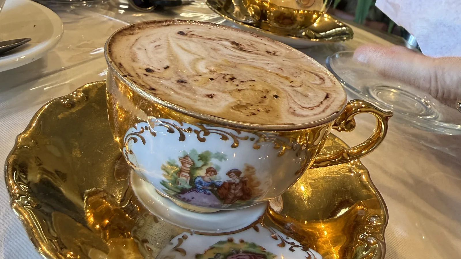 Cappuccino servido em xícara de porcelana decorada em uma cafeteria italiana